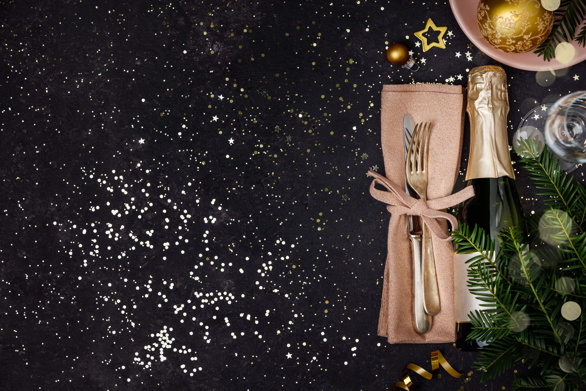 Champagne bottle with christmas decoration on dark background